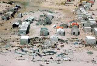 Somali houses are seen destroyed at the coast line of Hafun District in the north of Somalia in this picture released by World Food Program, taken on December 30, 2004. An estimated 30,000 to 50,000 Somalis need immediate relief aid in coastal towns devastated by waves whipped up by an earthquake in Asia, as efforts to rush relief food to Hafun, one of the worst-hit towns, have been held up because waves washed away the road to it, and diseases are now starting to take hold, the U.N. World Food Program (WFP) said in a statement. Picture taken December 30, 2004.       REUTERS/WFP Thomas Thompson/Handout